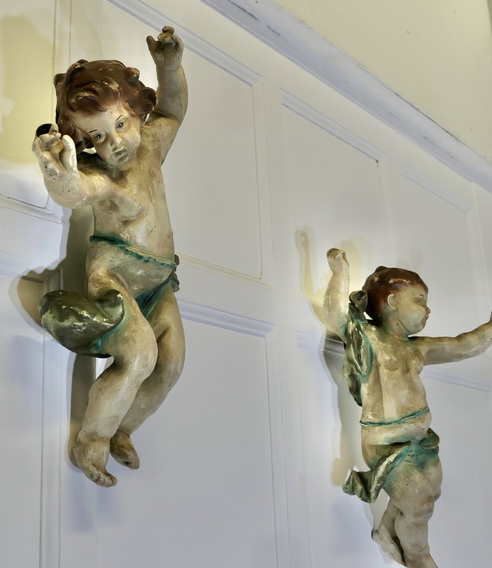A pair of 19th-century Italian carved wood putti featuring painted dynamic poses and green drapery. View XII