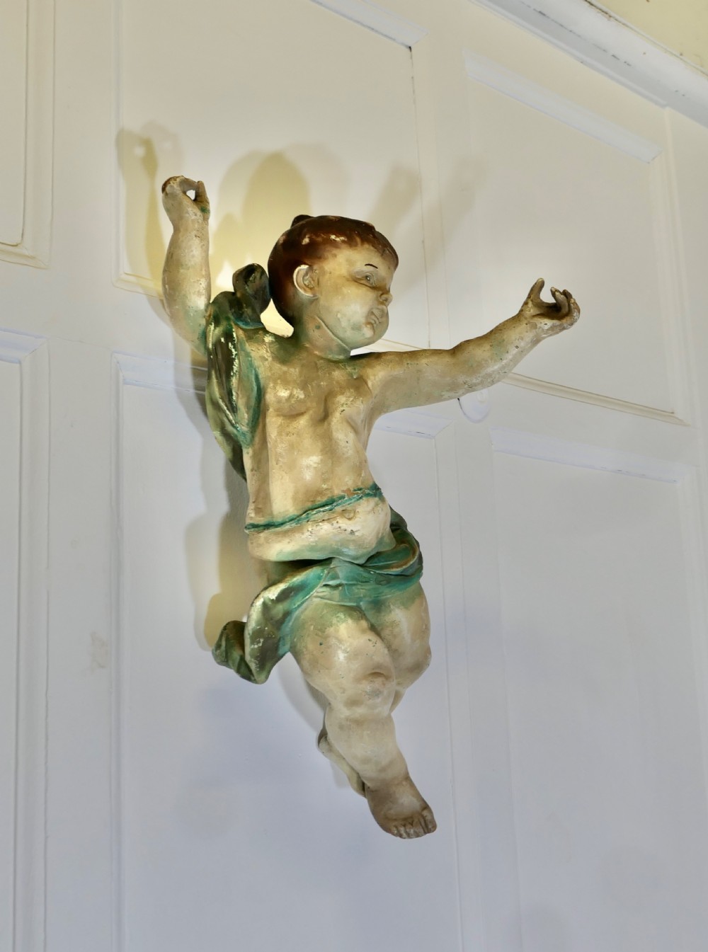 A pair of 19th-century Italian carved wood putti featuring painted dynamic poses and green drapery. View XIII