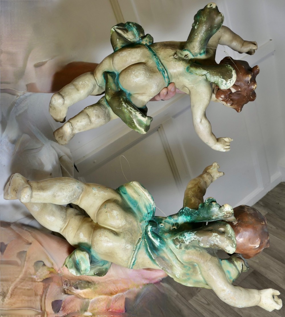 A pair of 19th-century Italian carved wood putti featuring painted dynamic poses and green drapery. View XIV