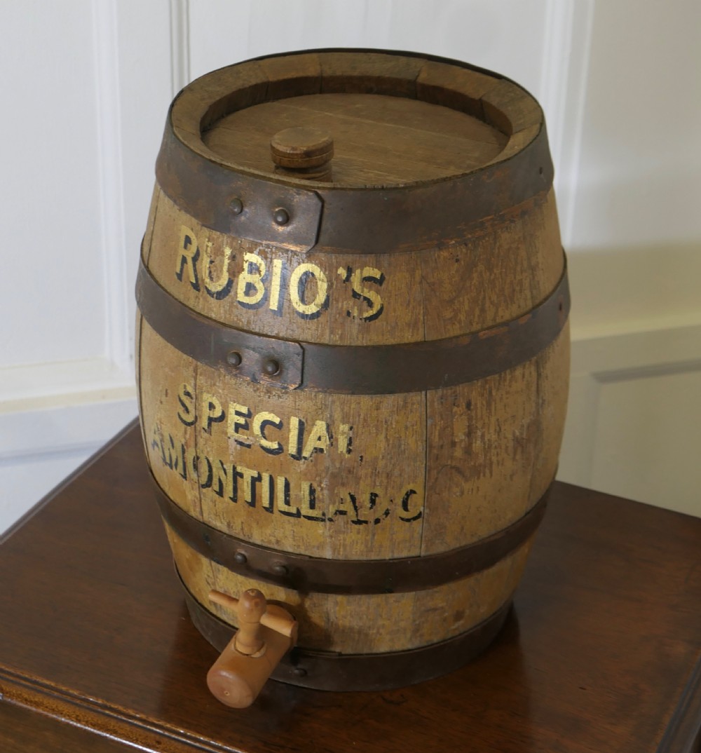 A small oak sherry barrel featuring stencilled text reading RUBIOS SPECIAL AMONTILLADO with metal hoops and a wooden tap. View II
