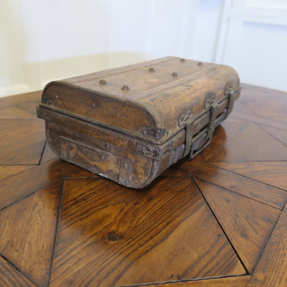 An antique patinated steel travel trunk featuring riveted metal edges, brass latches, and stencilled lettering reading Best Steel. View II