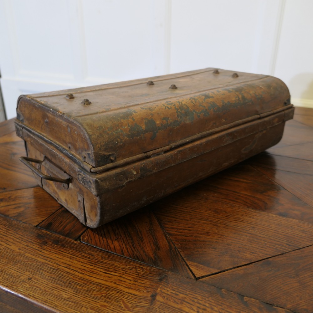 An antique patinated steel travel trunk featuring riveted metal edges, brass latches, and stencilled lettering reading Best Steel. View V