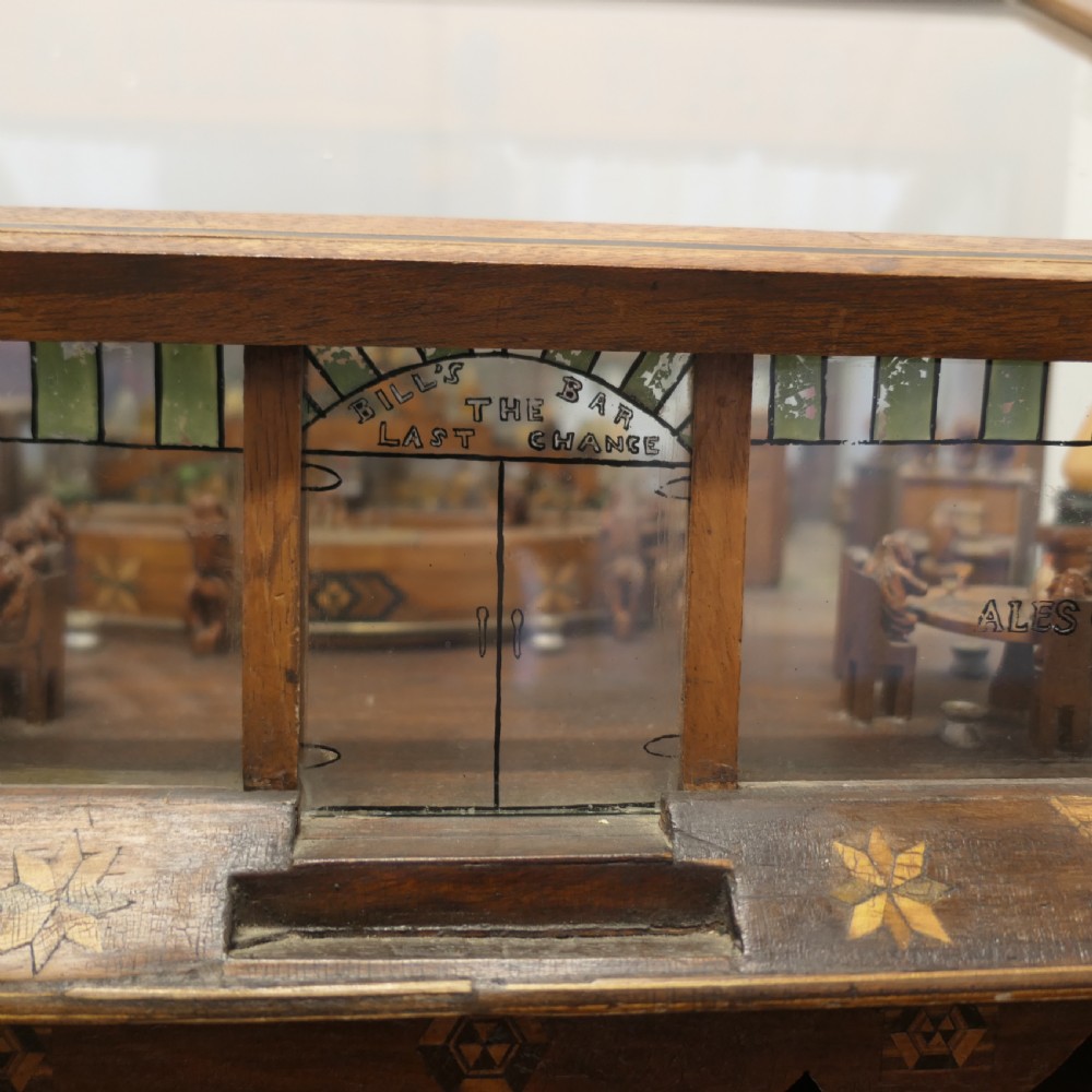 An early 20th-century wooden diorama display case featuring a miniature scene of a monkey saloon titled Bills Bar. View V