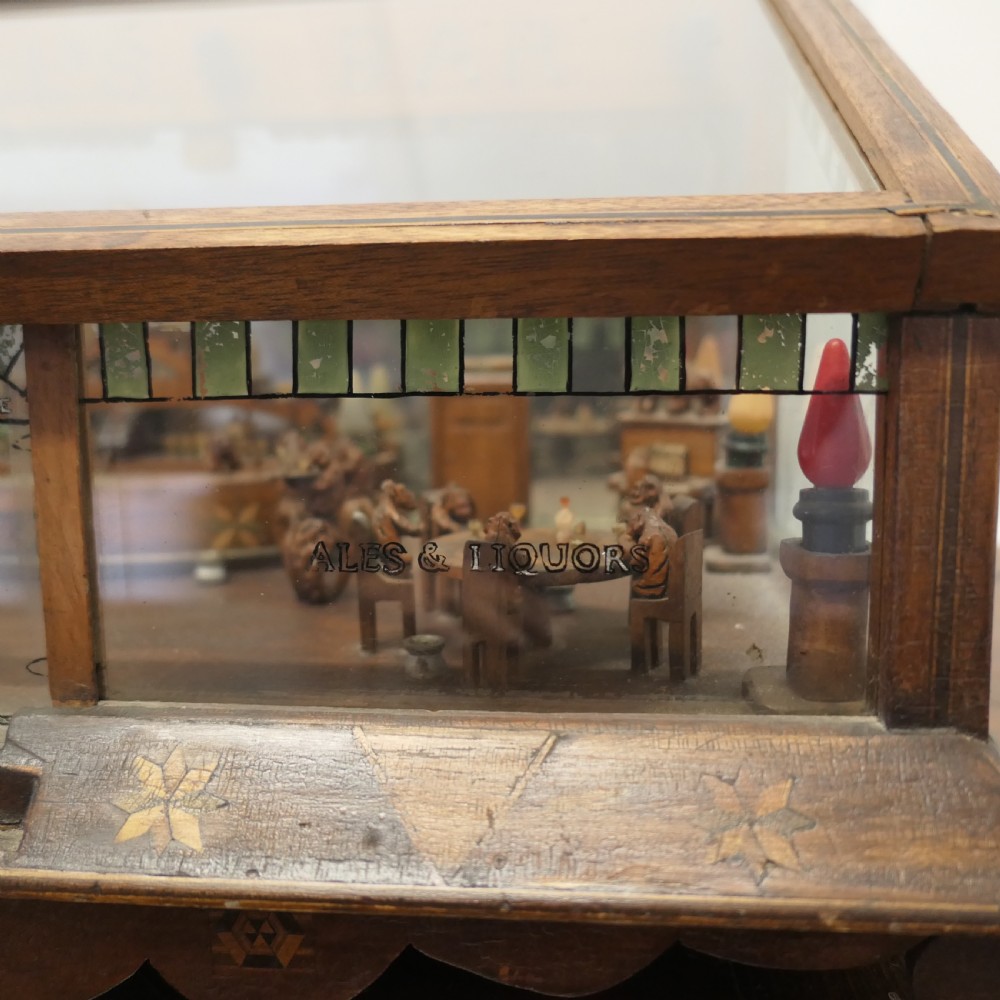 An early 20th-century wooden diorama display case featuring a miniature scene of a monkey saloon titled Bills Bar. View VI