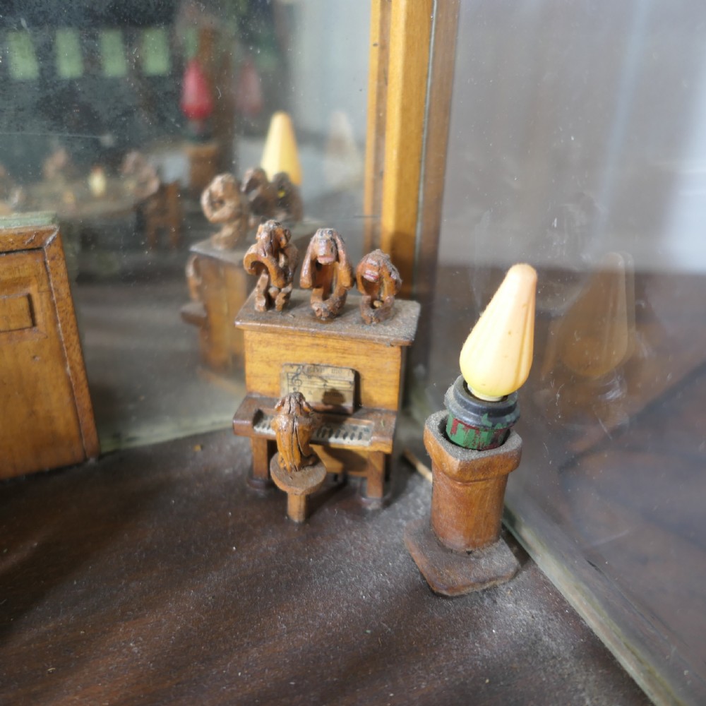 An early 20th-century wooden diorama display case featuring a miniature scene of a monkey saloon titled Bills Bar. View VII