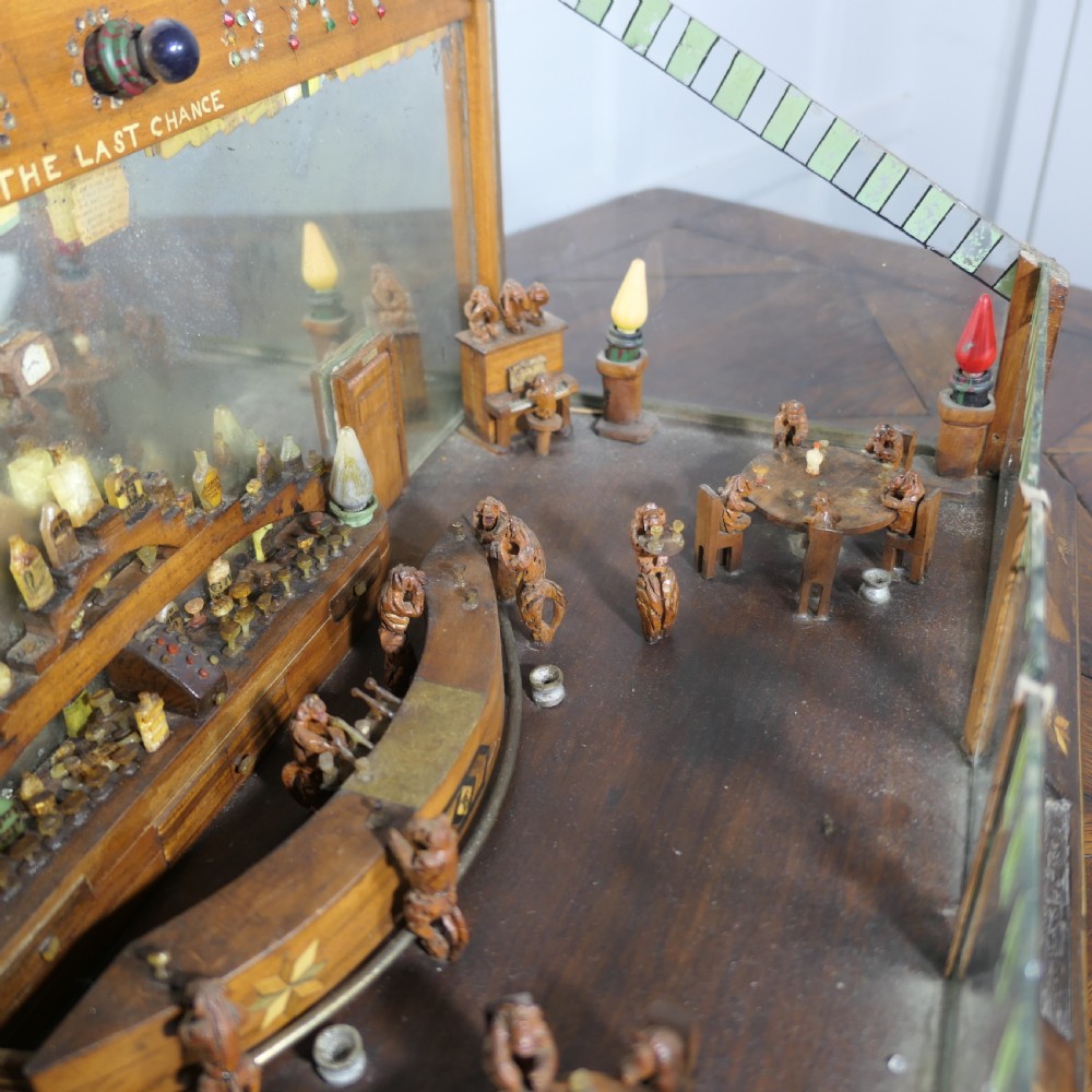 An early 20th-century wooden diorama display case featuring a miniature scene of a monkey saloon titled Bills Bar. View VIII