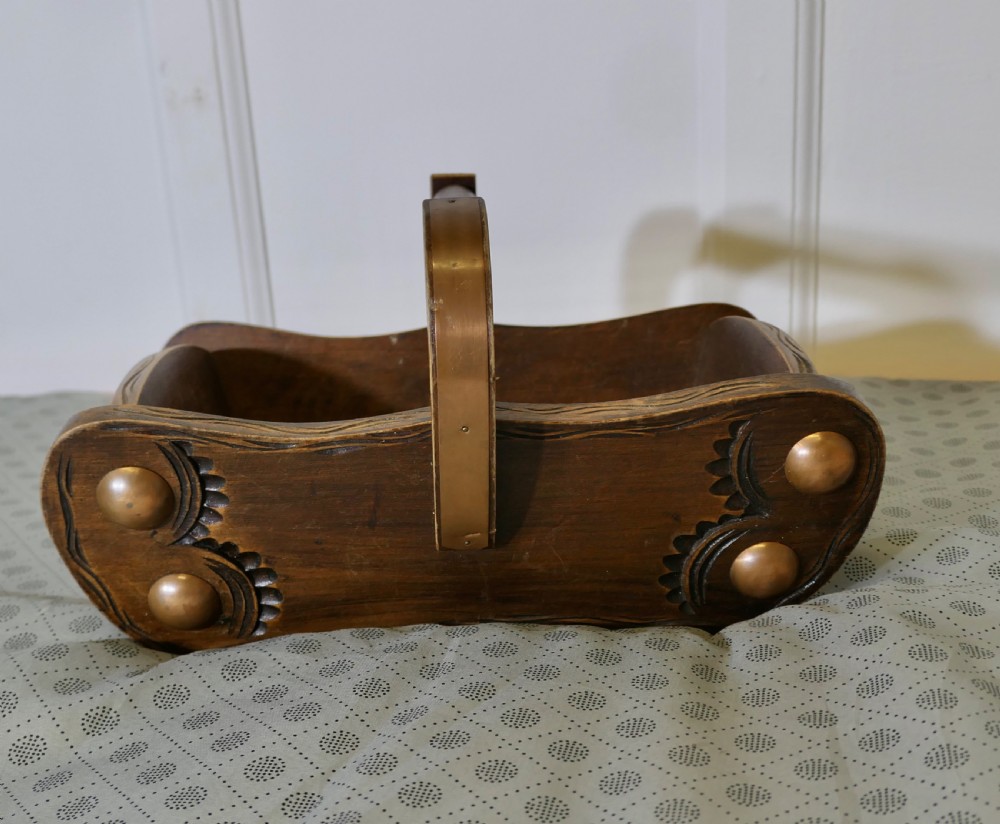 A carved dark oak Arts and Crafts style basket featuring elevated copper stud bosses and a central wooden handle. View II