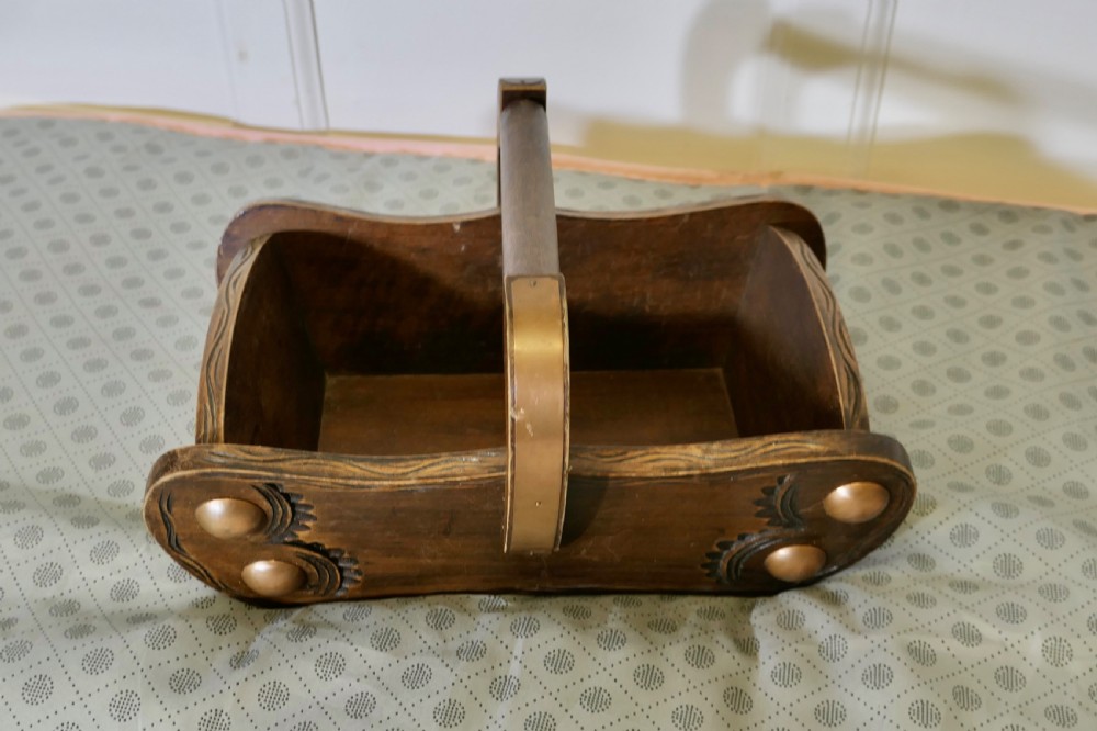 A carved dark oak Arts and Crafts style basket featuring elevated copper stud bosses and a central wooden handle. View III
