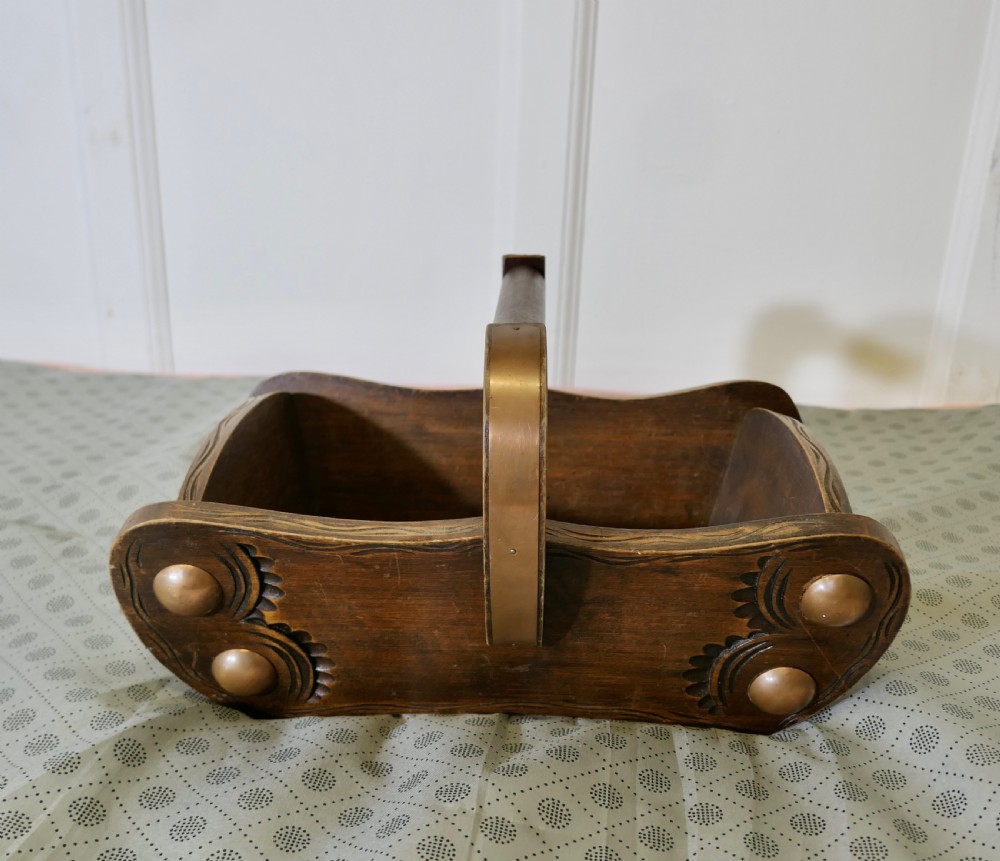 A carved dark oak Arts and Crafts style basket featuring elevated copper stud bosses and a central wooden handle. View VI