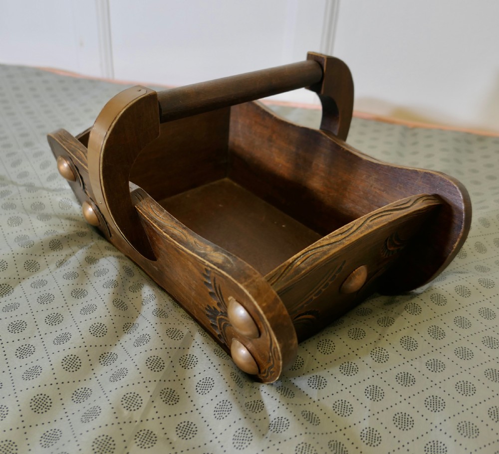A carved dark oak Arts and Crafts style basket featuring elevated copper stud bosses and a central wooden handle. View VII