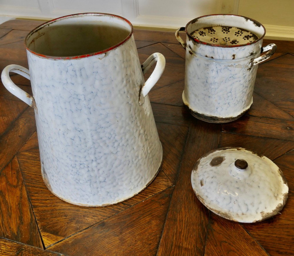 A tall antique white and blue marbled enamel coffee urn featuring a brass tap near the base, loop side handles, and red trim along the rim. View VII