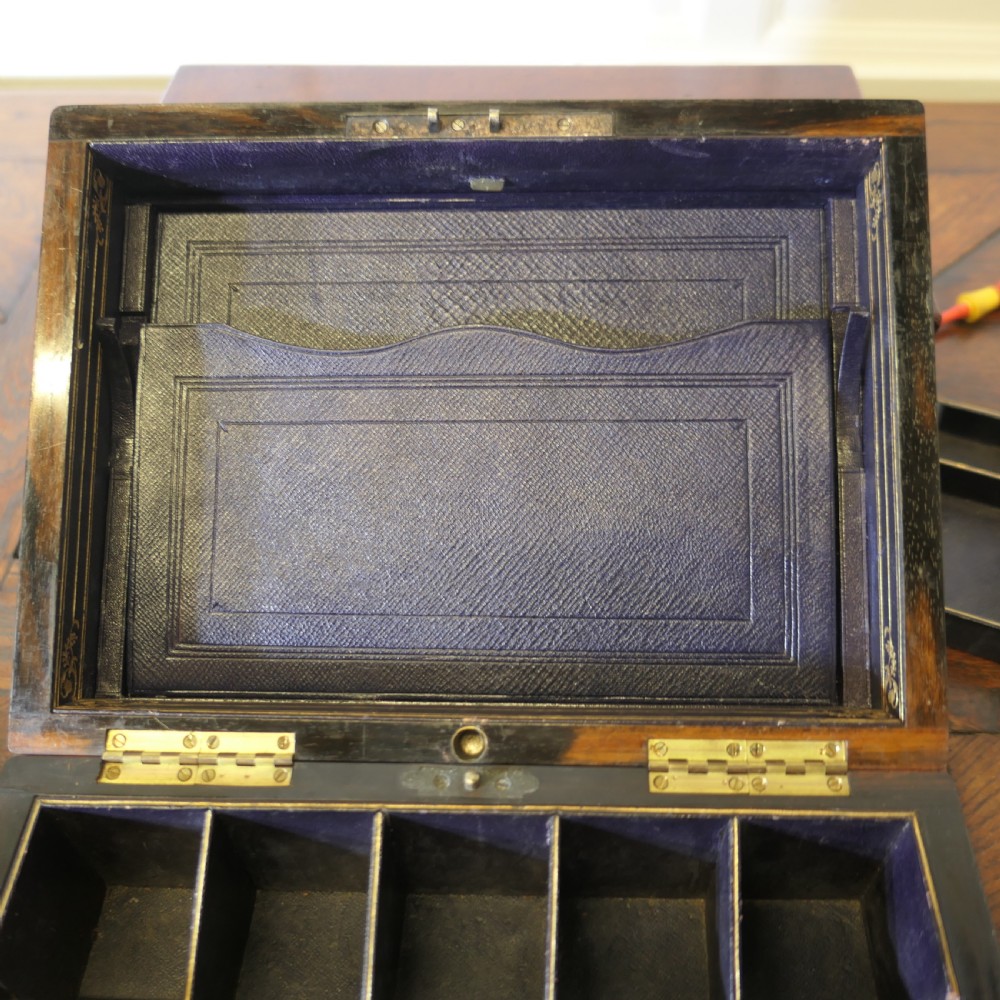 A set of three polished antique burr walnut storage boxes featuring brass keyhole escutcheons resting on a parquet floor. View VII