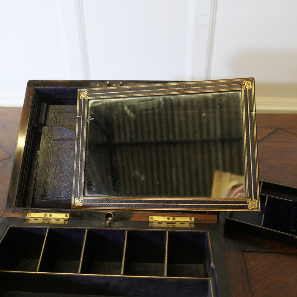 A set of three polished antique burr walnut storage boxes featuring brass keyhole escutcheons resting on a parquet floor. View VIII