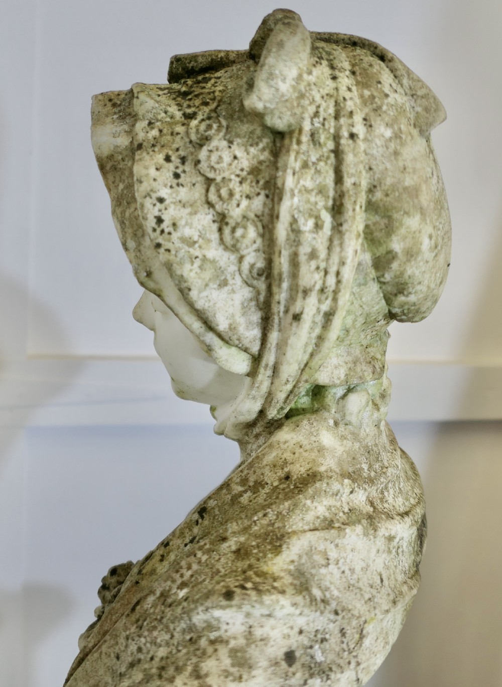 A 19th-century carved Carrara marble portrait bust depicting a young girl wearing a bonnet, mounted on a turned circular socle. View XI