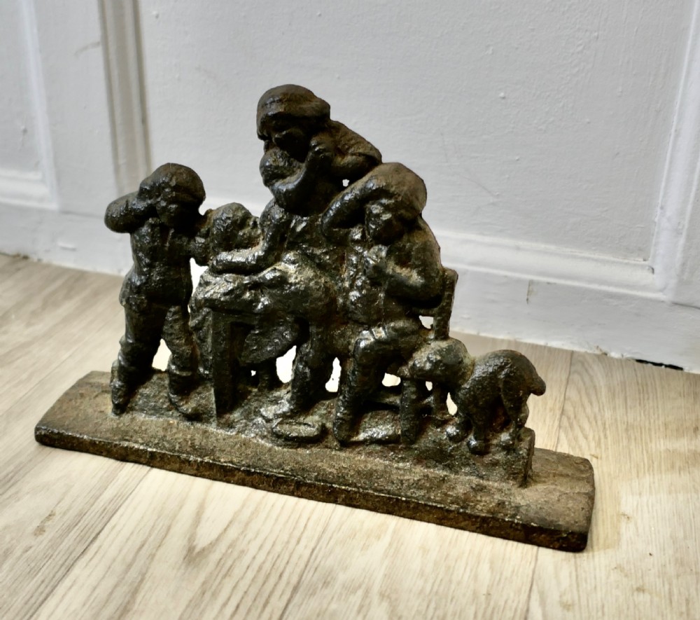 A 19th-century dark cast iron doorstop featuring a figurative narrative scene mounted on a flat rectangular plinth base. View IV