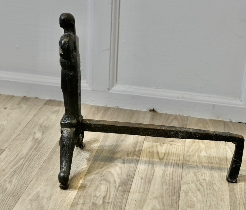 A pair of dark cast iron French Gothic andirons featuring standing guardian figures on scrolled tripod bases. View IV