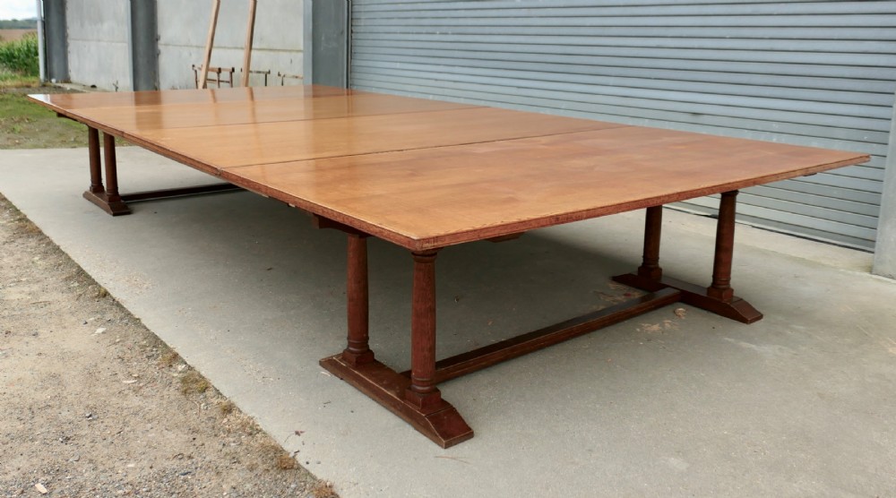 An exceptionally long Arts and Crafts solid oak banqueting table supported by columned trestle bases and structural stretchers. View II