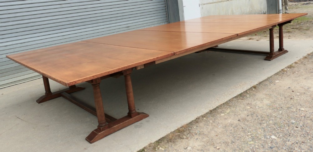 An exceptionally long Arts and Crafts solid oak banqueting table supported by columned trestle bases and structural stretchers. View VI
