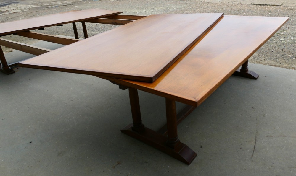 An exceptionally long Arts and Crafts solid oak banqueting table supported by columned trestle bases and structural stretchers. View VII