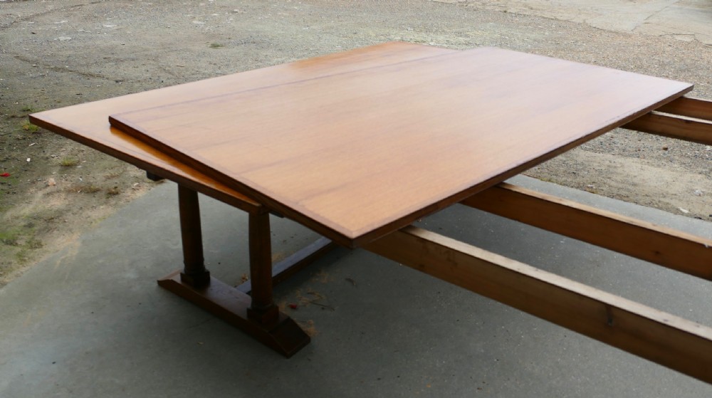 An exceptionally long Arts and Crafts solid oak banqueting table supported by columned trestle bases and structural stretchers. View VIII