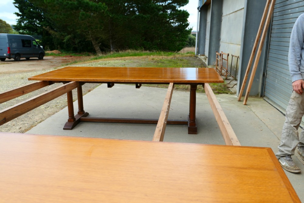 An exceptionally long Arts and Crafts solid oak banqueting table supported by columned trestle bases and structural stretchers. View IX