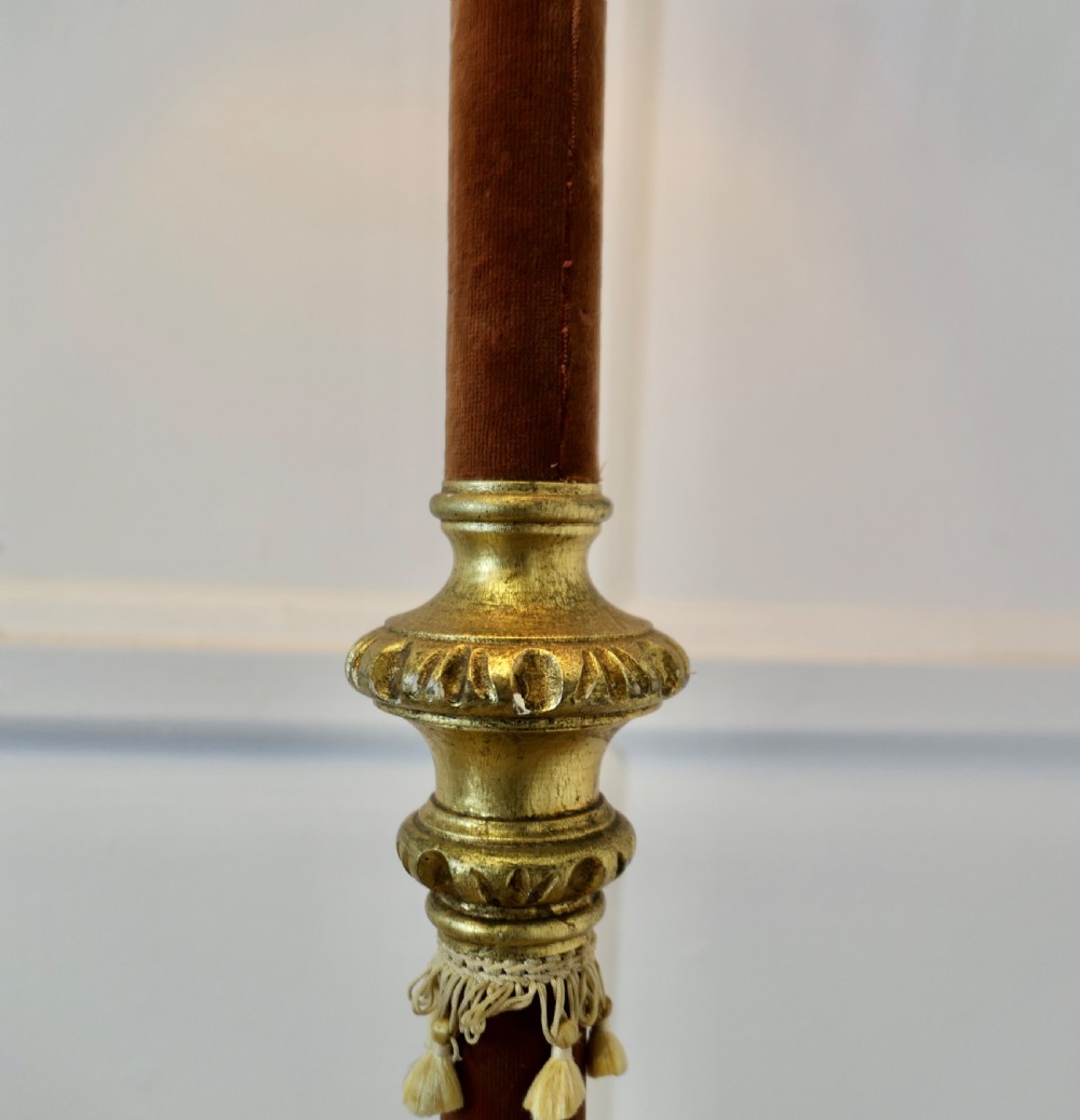 An antique French floor lamp with a gilded metal base, a velvet-wrapped central column, and a pink fabric lampshade featuring detailed fringe tassels. View VII