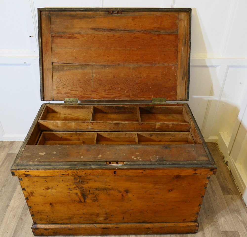 A rectangular Victorian pine carpenters chest featuring visible dovetail joinery, a hinged lid, and a keyhole escutcheon. View V