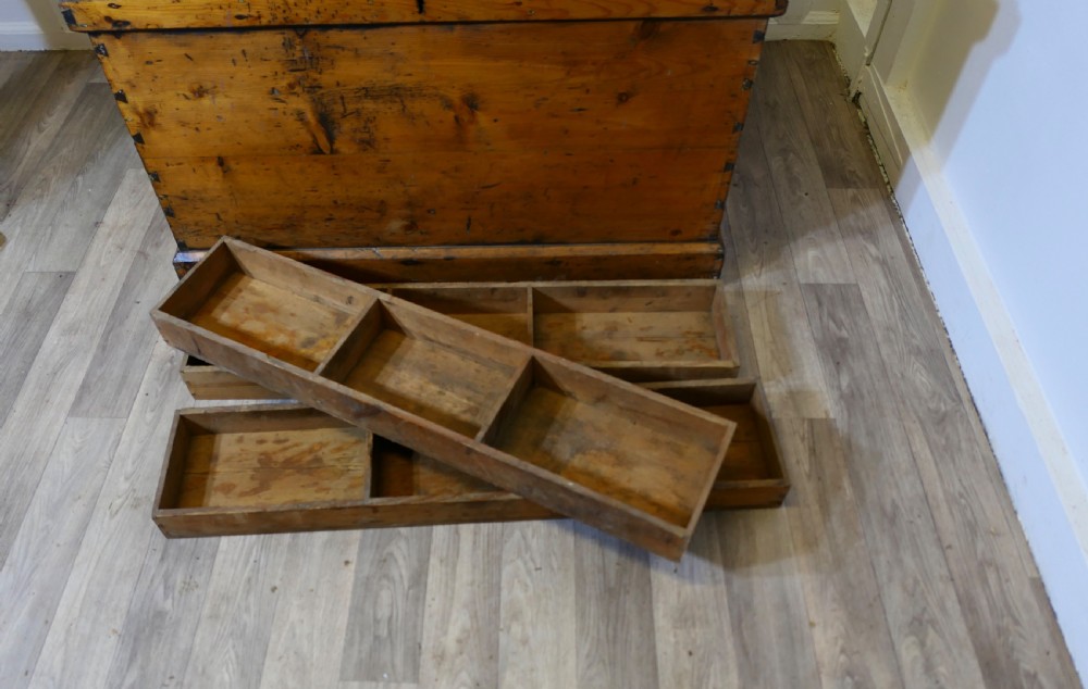 A rectangular Victorian pine carpenters chest featuring visible dovetail joinery, a hinged lid, and a keyhole escutcheon. View VI