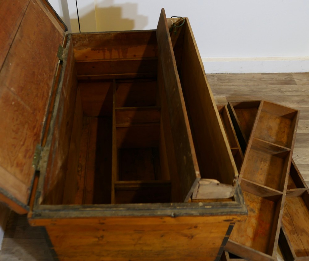 A rectangular Victorian pine carpenters chest featuring visible dovetail joinery, a hinged lid, and a keyhole escutcheon. View VII