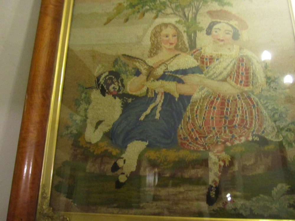 A nineteenth-century framed Scottish wool needlepoint picture depicting figures in Highland dress with a dog set within a wide cushion-moulded maple frame. View IV