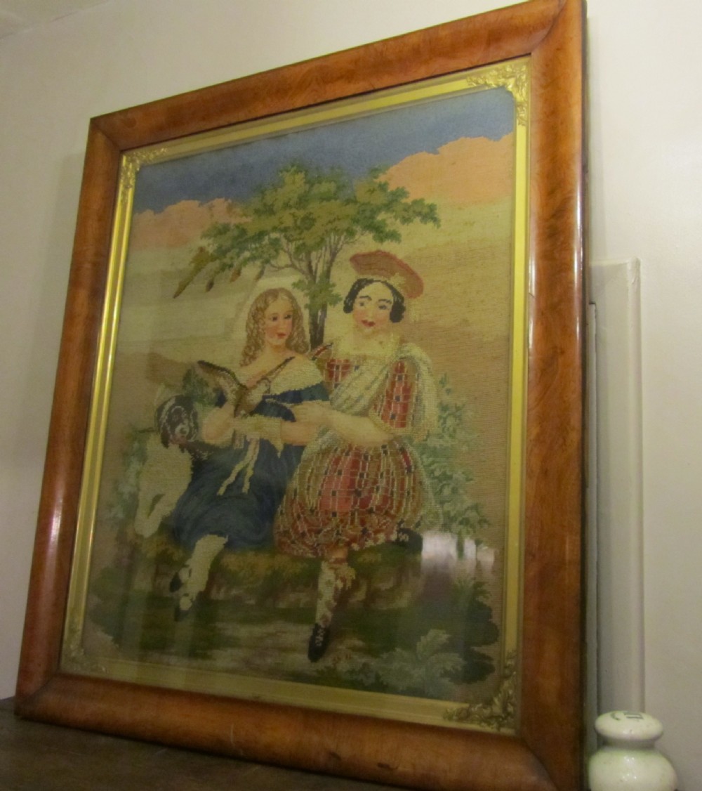A nineteenth-century framed Scottish wool needlepoint picture depicting figures in Highland dress with a dog set within a wide cushion-moulded maple frame. View III
