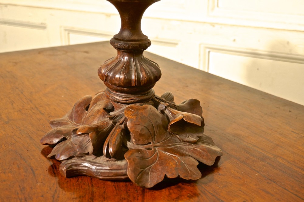 A Victorian Black Forest carved wooden epergne with a leaf base supporting a shallow etched crystal dish and a tall frosted trumpet vase. View V