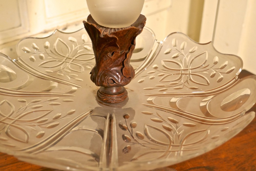 A Victorian Black Forest carved wooden epergne with a leaf base supporting a shallow etched crystal dish and a tall frosted trumpet vase. View VI