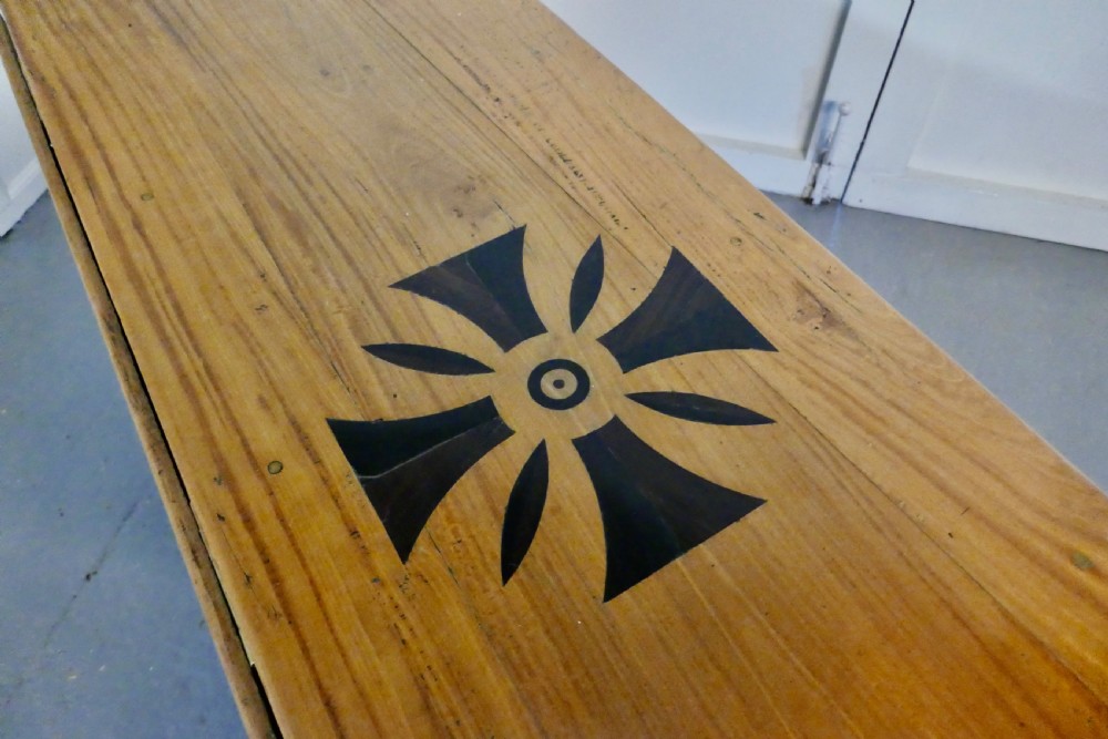 An oval wooden gateleg dining table featuring a central geometric star inlay, turned legs, and foldable drop leaves. View II