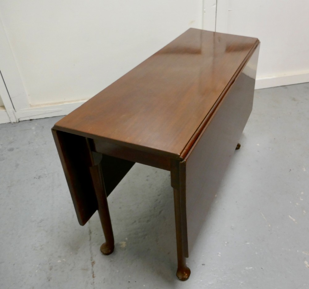 Folded Georgian mahogany drop-leaf dining table with straight turned legs terminating in pad feet. View III