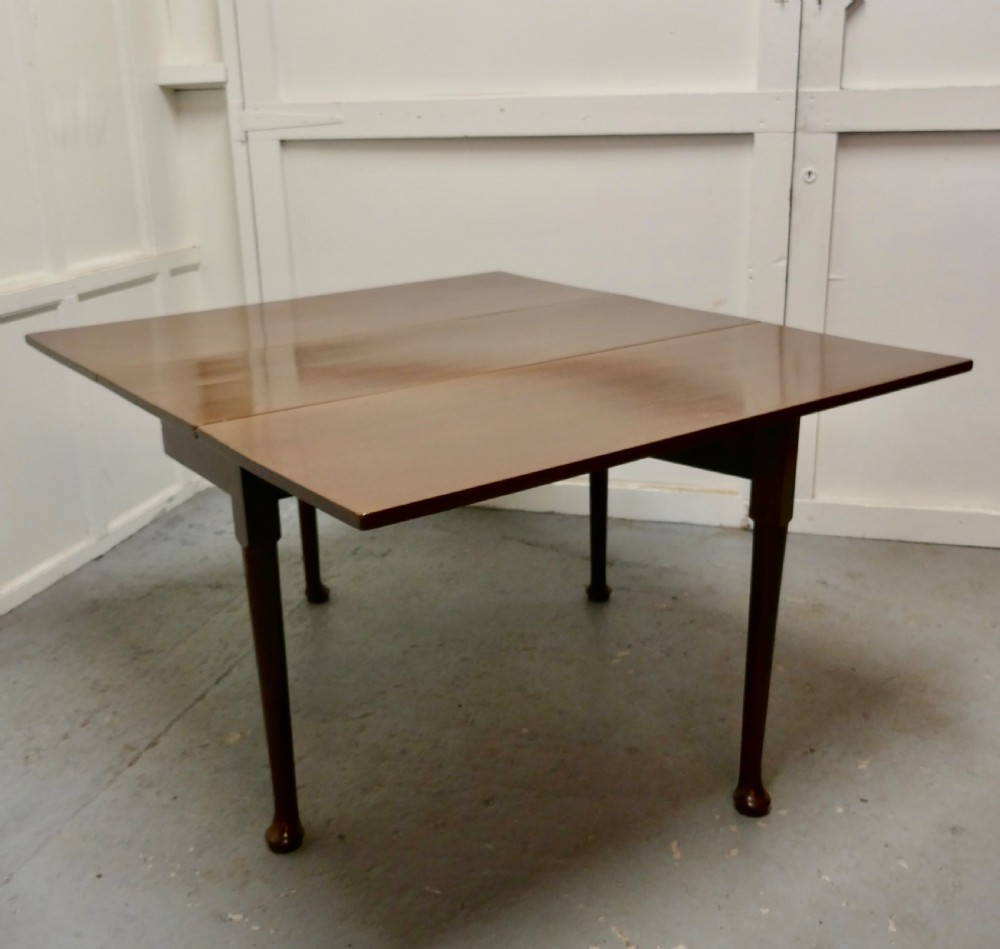 Folded Georgian mahogany drop-leaf dining table with straight turned legs terminating in pad feet. View V