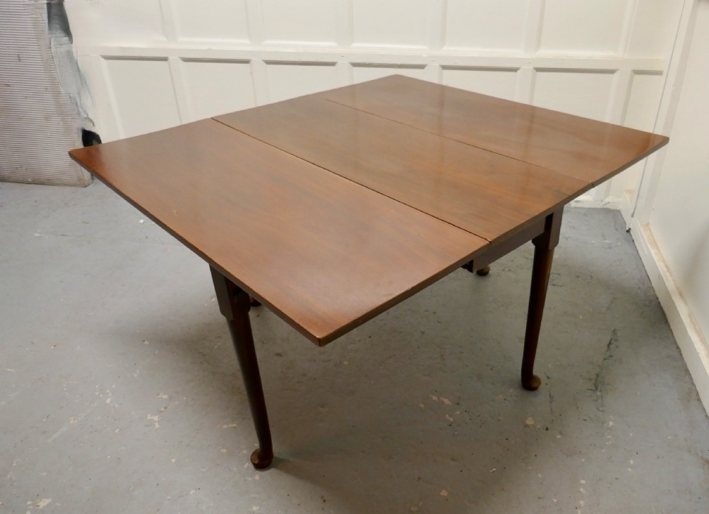 Folded Georgian mahogany drop-leaf dining table with straight turned legs terminating in pad feet. View VII
