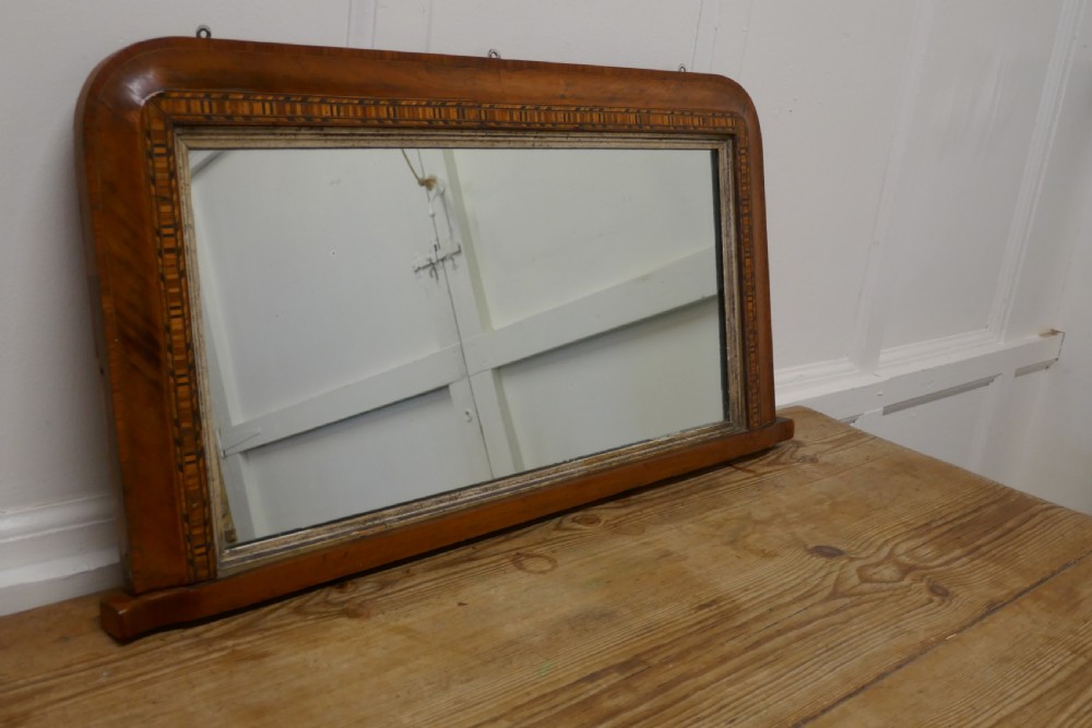A Victorian walnut overmantel mirror featuring rounded upper corners, an intricate mosaic Tunbridge ware inlay border, and a gilt inner slip frame. View II