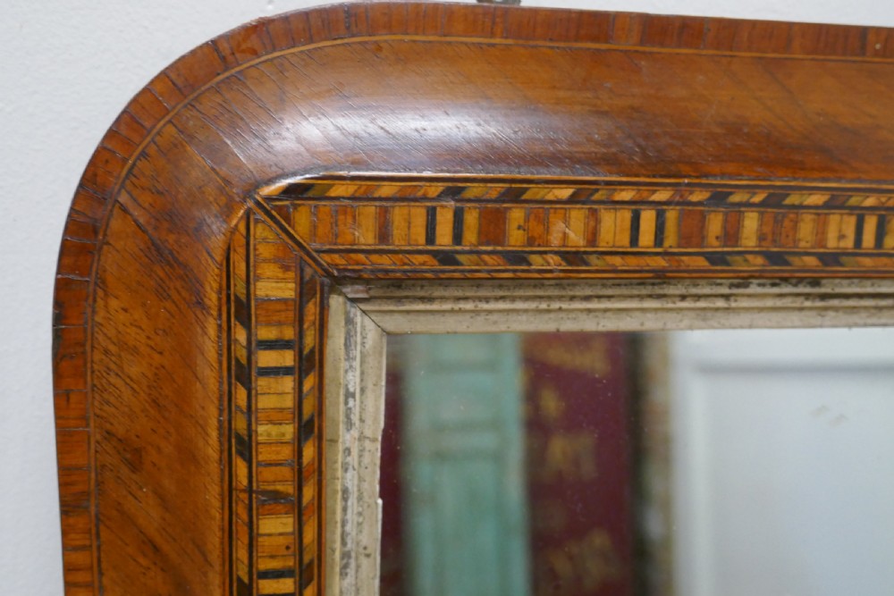 A Victorian walnut overmantel mirror featuring rounded upper corners, an intricate mosaic Tunbridge ware inlay border, and a gilt inner slip frame. View III