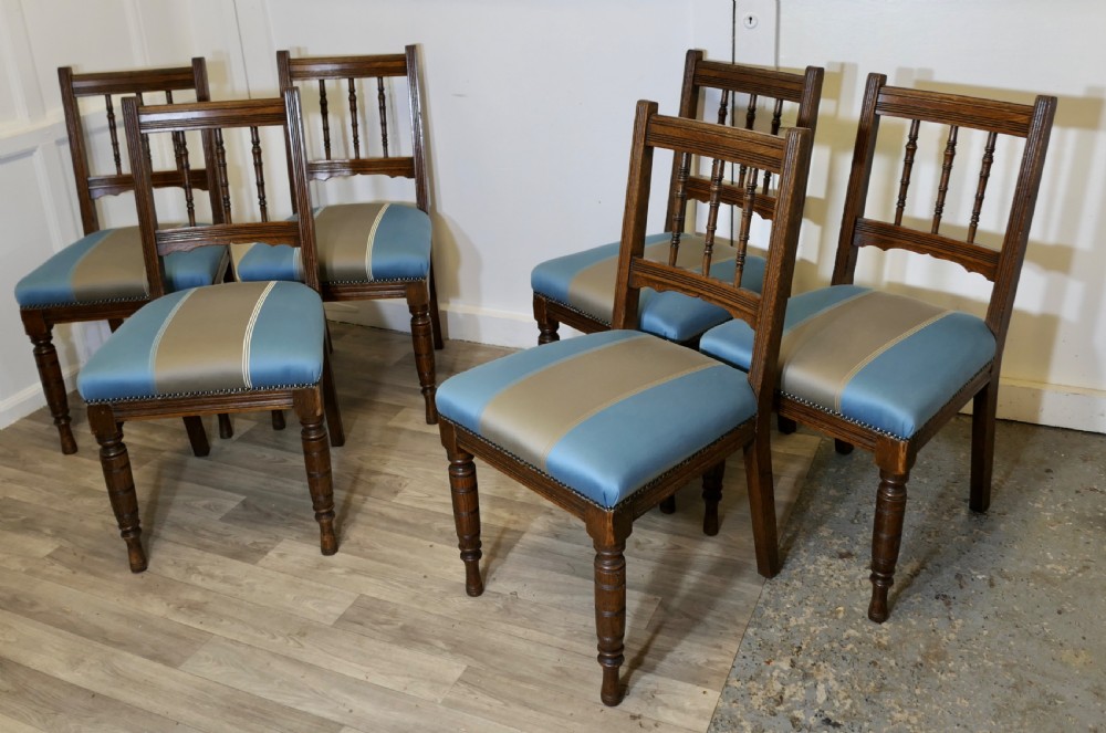 A set of six Edwardian oak dining chairs featuring turned front legs, vertical back spindles, and blue and grey striped satin seats with stud detail. View III