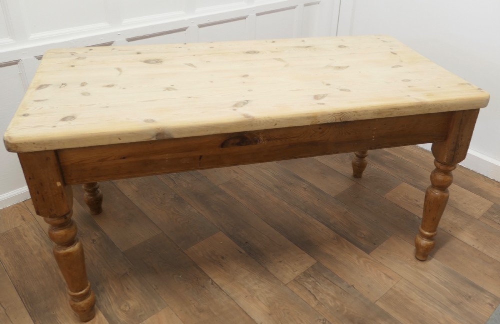 A rectangular pine kitchen table with a scrubbed natural wood top, turned legs, and a single drawer with a wooden knob pull. View IV