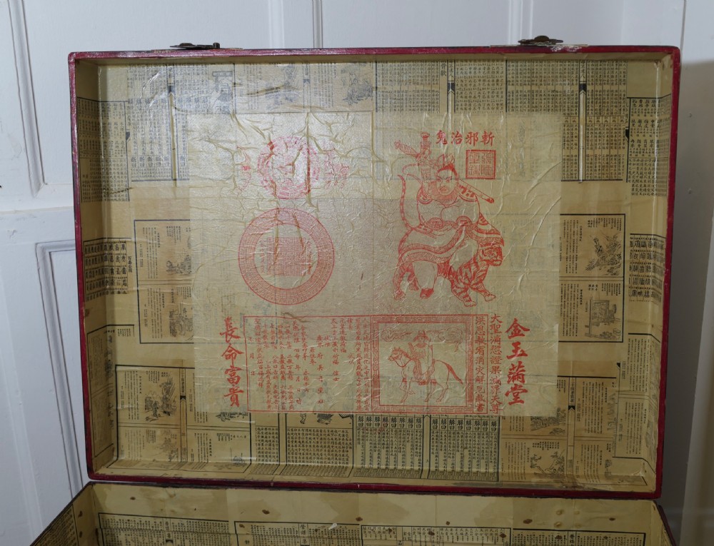 A red painted Chinoiserie marriage chest decorated with lotus motifs, raised on a low timber stand with brass clasps. View VIII