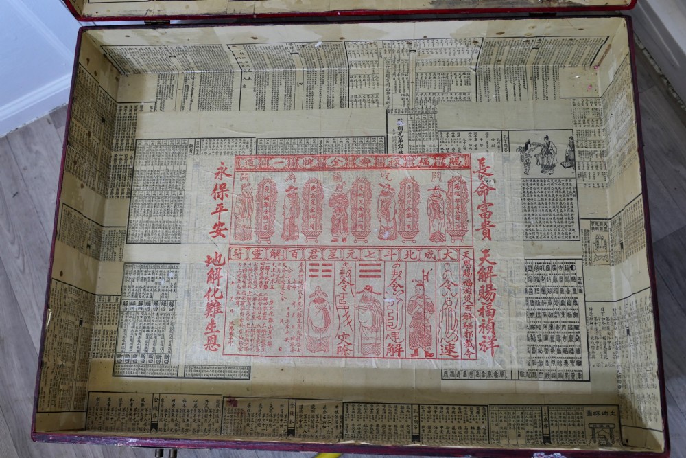 A red painted Chinoiserie marriage chest decorated with lotus motifs, raised on a low timber stand with brass clasps. View IX