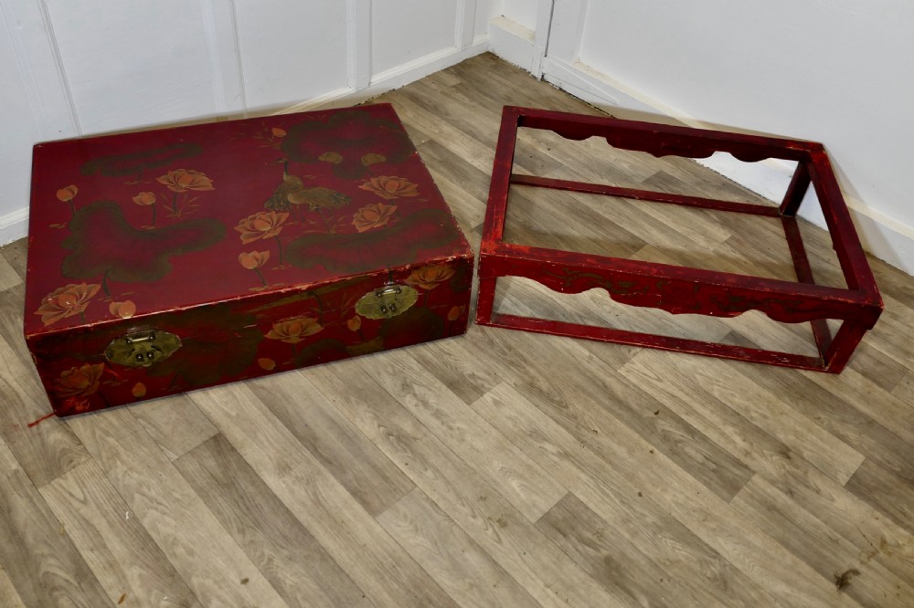 A red painted Chinoiserie marriage chest decorated with lotus motifs, raised on a low timber stand with brass clasps. View XI