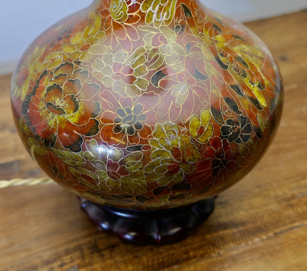 A baluster-shaped cloisonne table lamp featuring floral enamelling and a carved dark wood stand under a textured brown fabric lampshade. View II