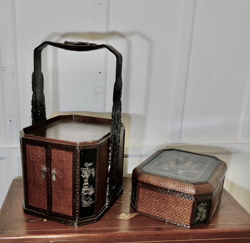 An octagonal Chinese wedding basket constructed from woven bamboo and dark lacquered wood with a tall overhead handle and double doors at the base. View VI