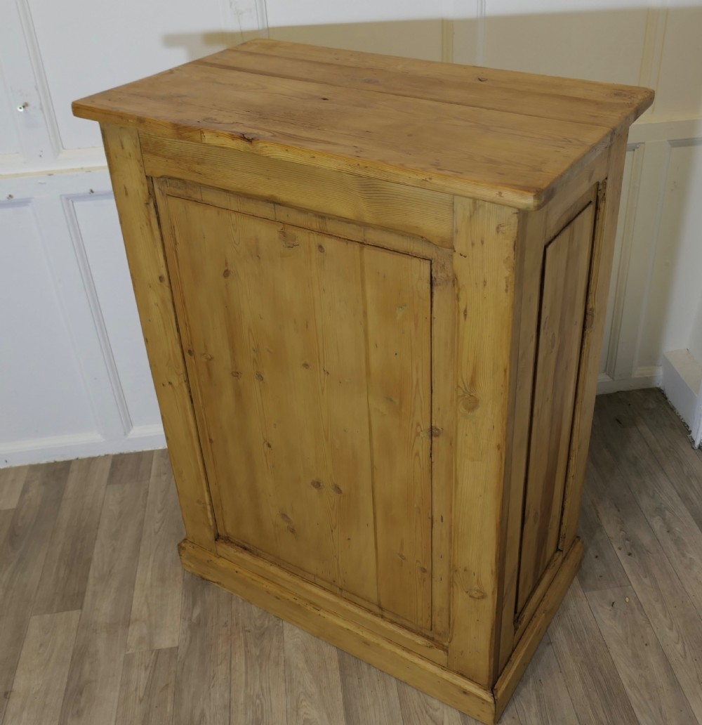 A tall standing pine desk featuring two upper drawers with dark metal cup handles above open lower shelving and panelled sides. View VI