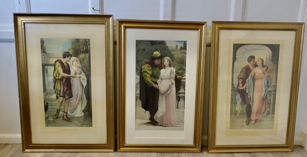 A set of three 19th-century framed Pre-Raphaelite style prints displaying romantic couples in classical attire within gilded frames. View X