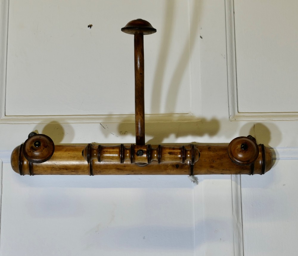 An antique French wall-mounted coat rack crafted from turned wood carved in a simulated bamboo design with turned hanging pegs. View VII