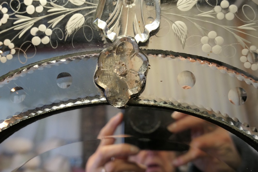A Venetian cushion wall mirror with an etched floral glass frame, a carved glass crest pediment, and an arched central mirror plate. View VIII